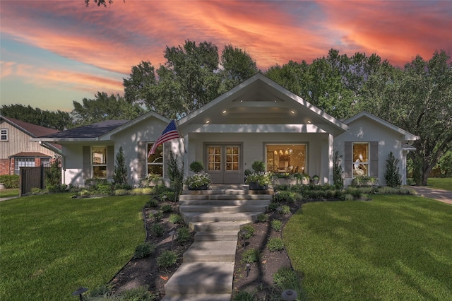 modern farmhouse style home with covered porch and a front yard