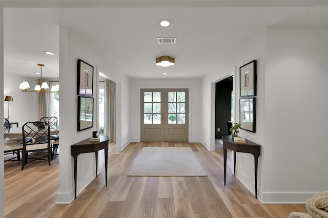 entrance foyer with light wood finished floors, recessed lighting, visible vents, and french doors