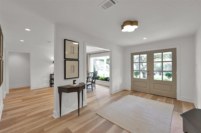 foyer with visible vents, baseboards, french doors, light wood-type flooring, and recessed lighting