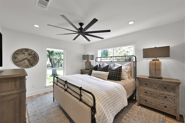 bedroom with light wood finished floors, visible vents, and recessed lighting