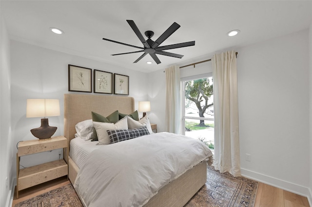 bedroom with a ceiling fan, baseboards, wood finished floors, and recessed lighting