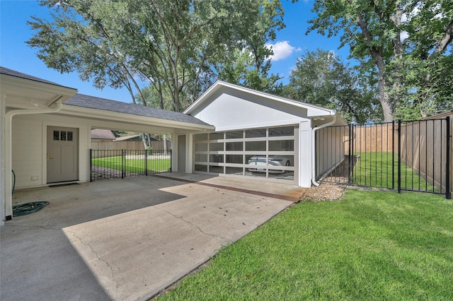 exterior space with a gate, fence, and a carport