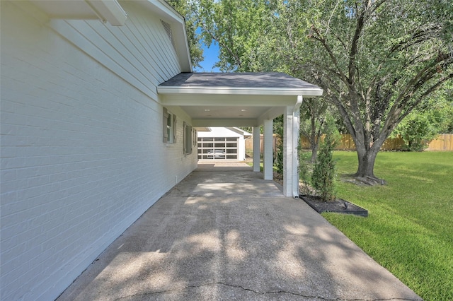 view of parking with an attached carport, driveway, and fence