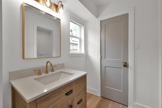 bathroom with wood finished floors and vanity