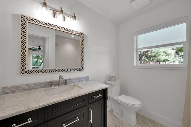 full bathroom featuring ceiling fan, tile patterned flooring, toilet, vanity, and baseboards