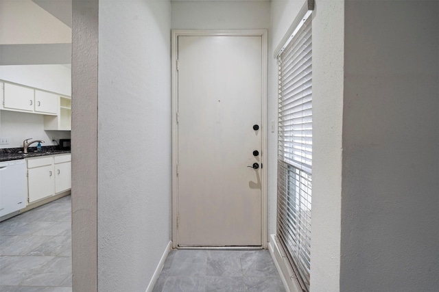 doorway to property with a sink