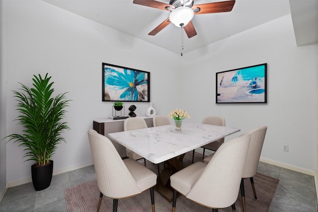 dining area featuring baseboards and a ceiling fan