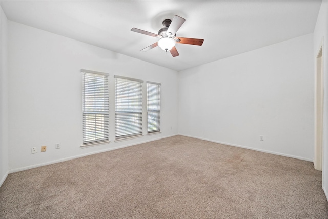 unfurnished room featuring ceiling fan, carpet, and baseboards