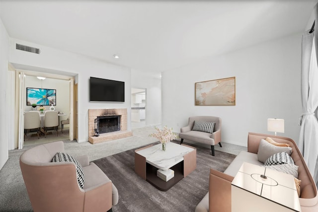 carpeted living area with a fireplace and visible vents