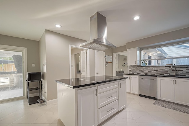 kitchen featuring island range hood, a sink, stainless steel dishwasher, tasteful backsplash, and dark countertops