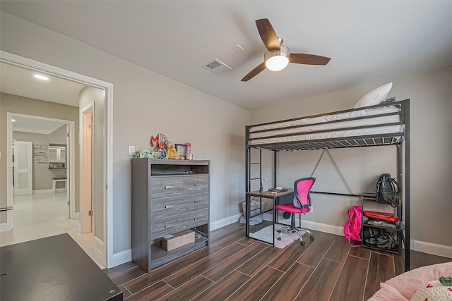 bedroom featuring baseboards, a ceiling fan, visible vents, and wood tiled floor