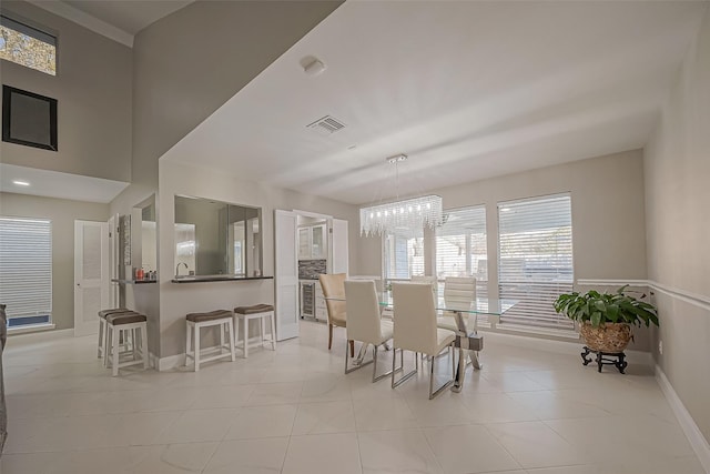 dining space with visible vents, a notable chandelier, baseboards, and light tile patterned flooring