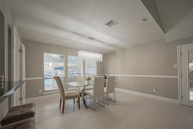 dining area with an inviting chandelier, visible vents, baseboards, and light tile patterned floors