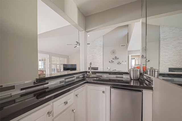 kitchen with refrigerator, visible vents, a ceiling fan, white cabinetry, and dark countertops