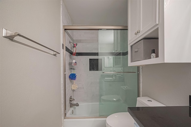 full bath featuring combined bath / shower with glass door and toilet