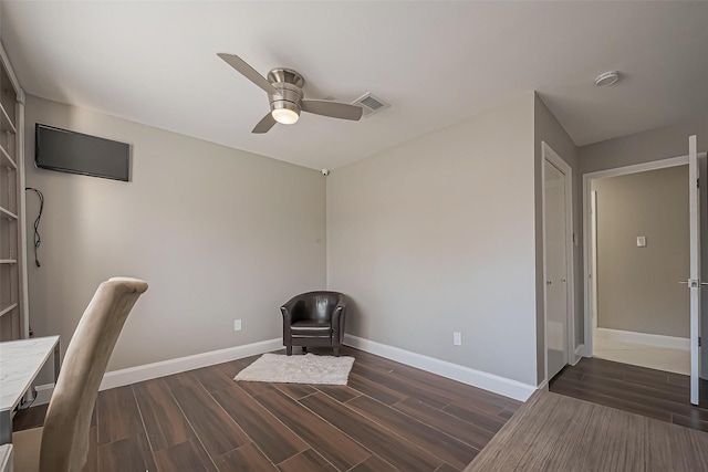 unfurnished office with ceiling fan, dark wood-style flooring, visible vents, and baseboards