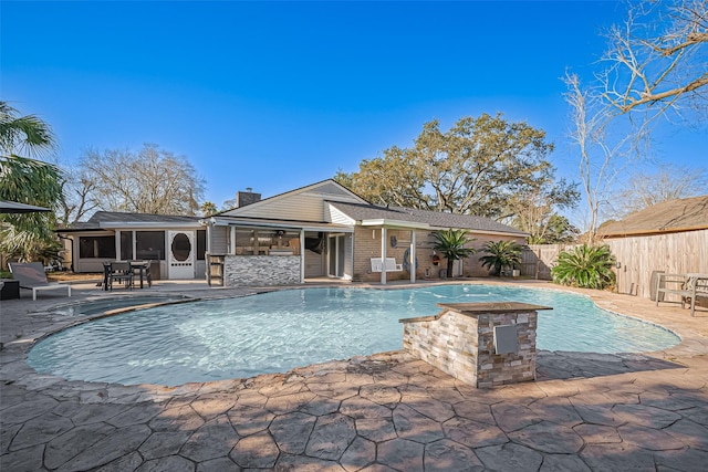 view of swimming pool with an outbuilding, a storage structure, and a patio area