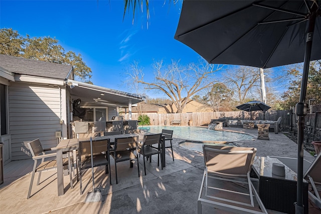 view of patio / terrace with outdoor dining area, a fenced backyard, and a fenced in pool