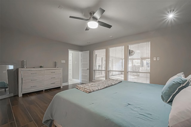 bedroom featuring dark wood-type flooring, ceiling fan, and baseboards