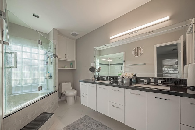 bathroom featuring a wealth of natural light, a sink, and a shower with shower door