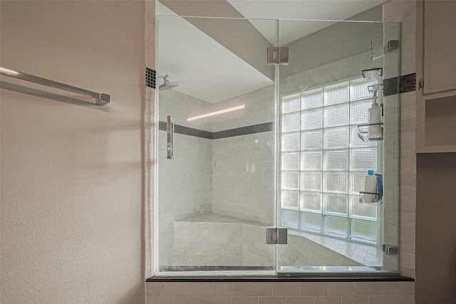 bathroom with a shower stall