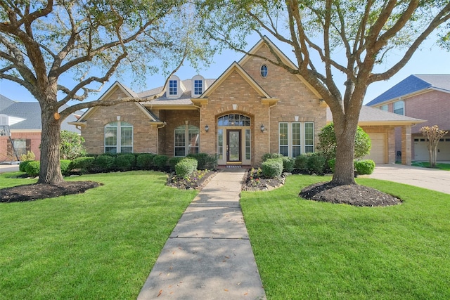 traditional home with a front lawn, a garage, brick siding, and concrete driveway