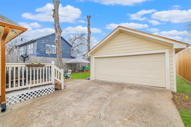 detached garage featuring fence