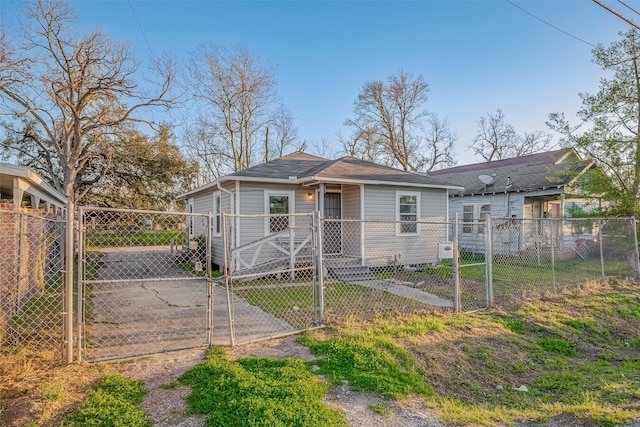 view of front of property featuring a gate, fence, and driveway