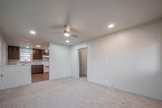 unfurnished living room with ceiling fan, recessed lighting, and light colored carpet