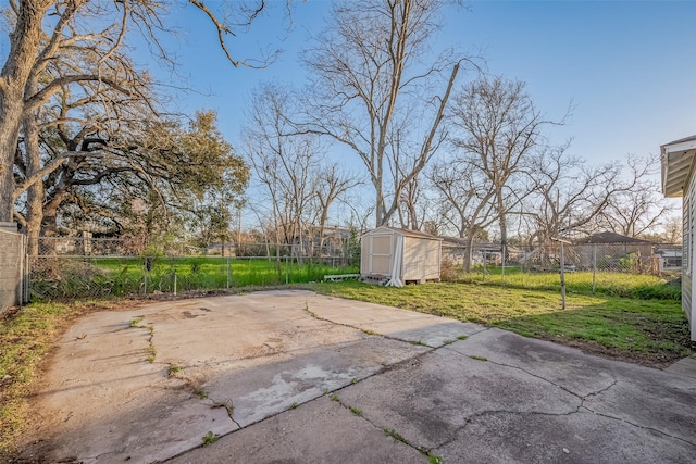 view of patio / terrace with an outbuilding, a fenced backyard, and a storage unit