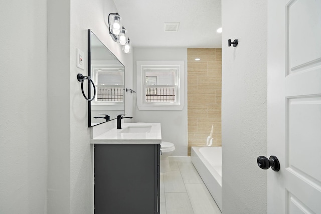 full bath with toilet, tile patterned floors, visible vents, and vanity