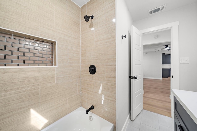 bathroom with shower / bath combination, visible vents, ceiling fan, tile patterned floors, and vanity