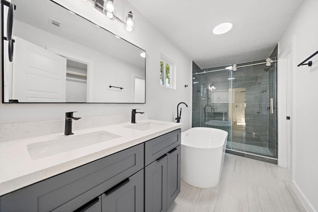 full bathroom featuring double vanity, a sink, visible vents, and a shower stall