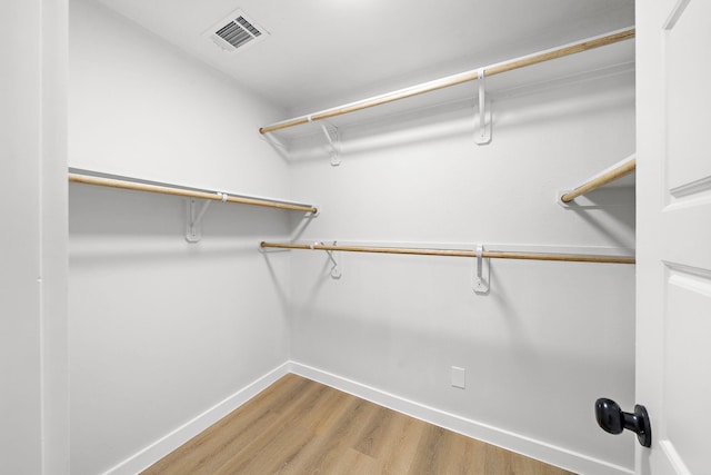 spacious closet with visible vents and wood finished floors