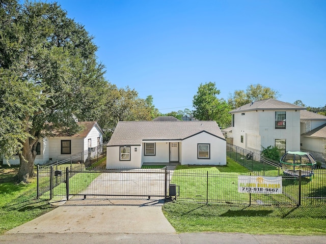 view of front of property with a fenced front yard, a gate, a front lawn, and stucco siding