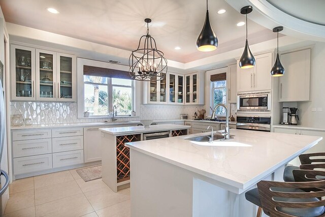 4214 Turks Pt, Galveston, TX 77554 - kitchen featuring stainless steel appliances, plenty of natural light, a center island with sink, and a sink