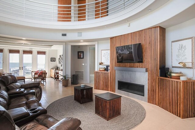 4214 Turks Pt, Galveston, TX 77554 - living room featuring french doors, visible vents, a towering ceiling, tile patterned flooring, and a tile fireplace