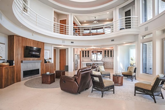 4214 Turks Pt, Galveston, TX 77554 - living area with a large fireplace, a high ceiling, visible vents, and light tile patterned flooring