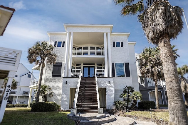 4214 Turks Pt, Galveston, TX 77554 - view of front facade with stairs, french doors, and a balcony