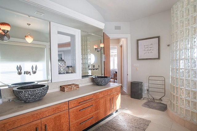 4214 Turks Pt, Galveston, TX 77554 - bathroom with vaulted ceiling, vanity, visible vents, and tile patterned floors