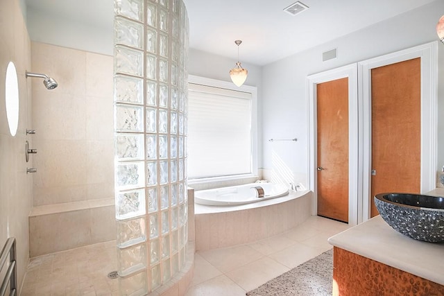 4214 Turks Pt, Galveston, TX 77554 - bathroom with visible vents, vanity, a bath, a walk in shower, and tile patterned floors