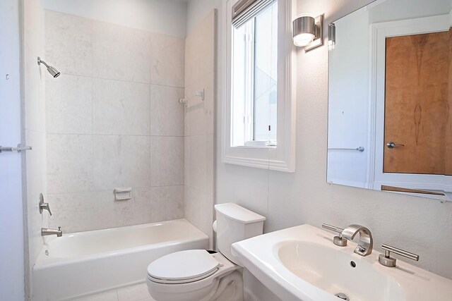 4214 Turks Pt, Galveston, TX 77554 - bathroom featuring washtub / shower combination, a sink, and toilet