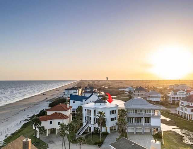 4214 Turks Pt, Galveston, TX 77554 - aerial view at dusk featuring a water view, a residential view, and a beach view