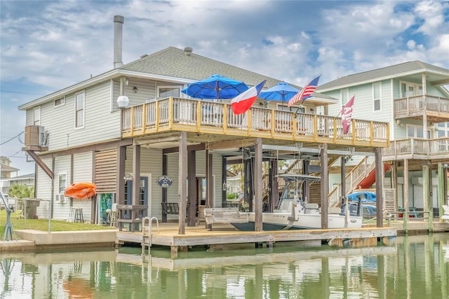 back of property featuring a water view