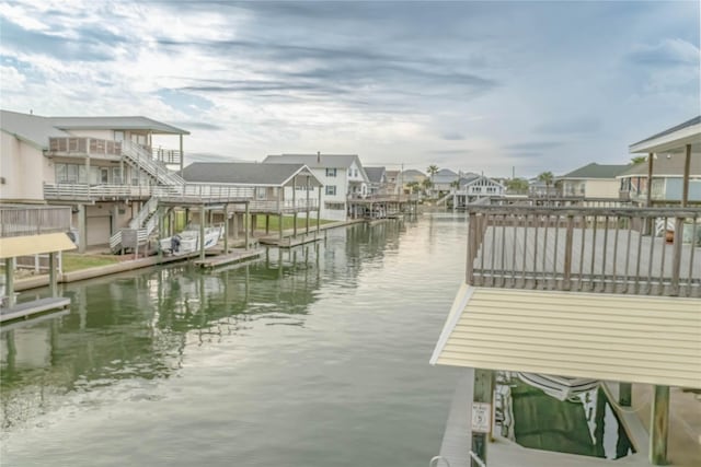 dock area featuring a water view and a residential view