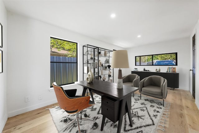 home office featuring light wood finished floors, baseboards, and recessed lighting