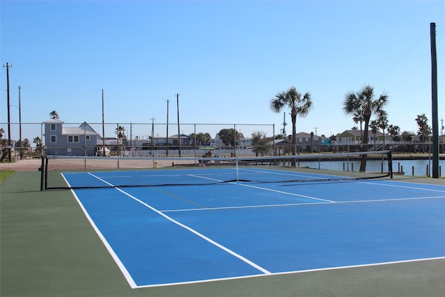 view of sport court featuring fence and a residential view