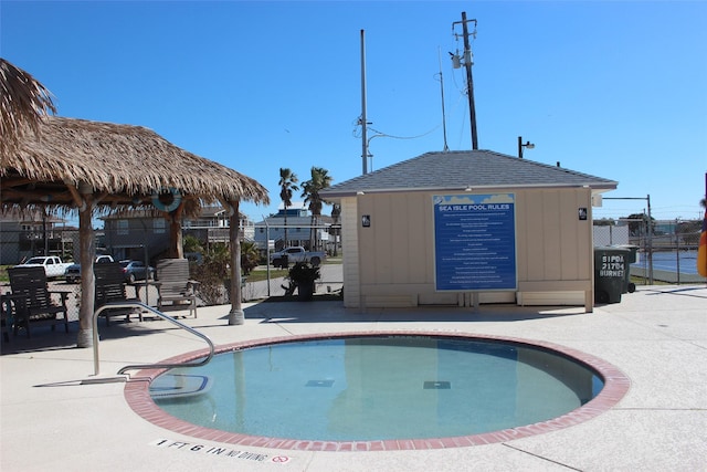 view of pool featuring a patio area and fence