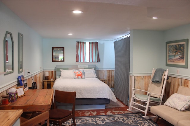 bedroom featuring a wainscoted wall and recessed lighting