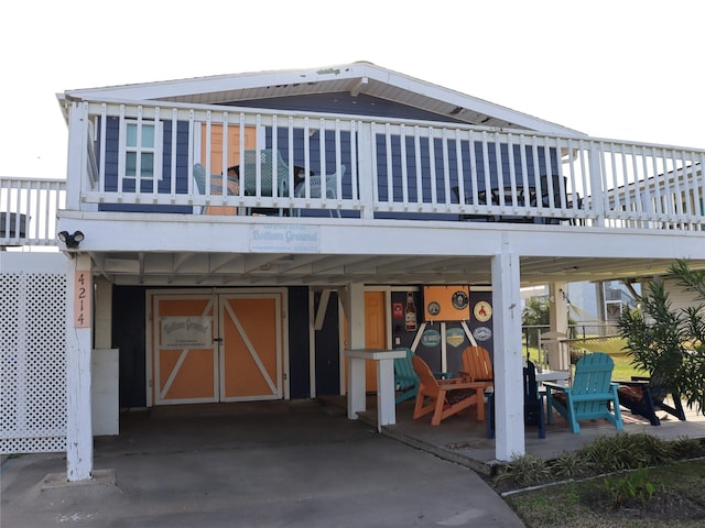 rear view of property featuring driveway